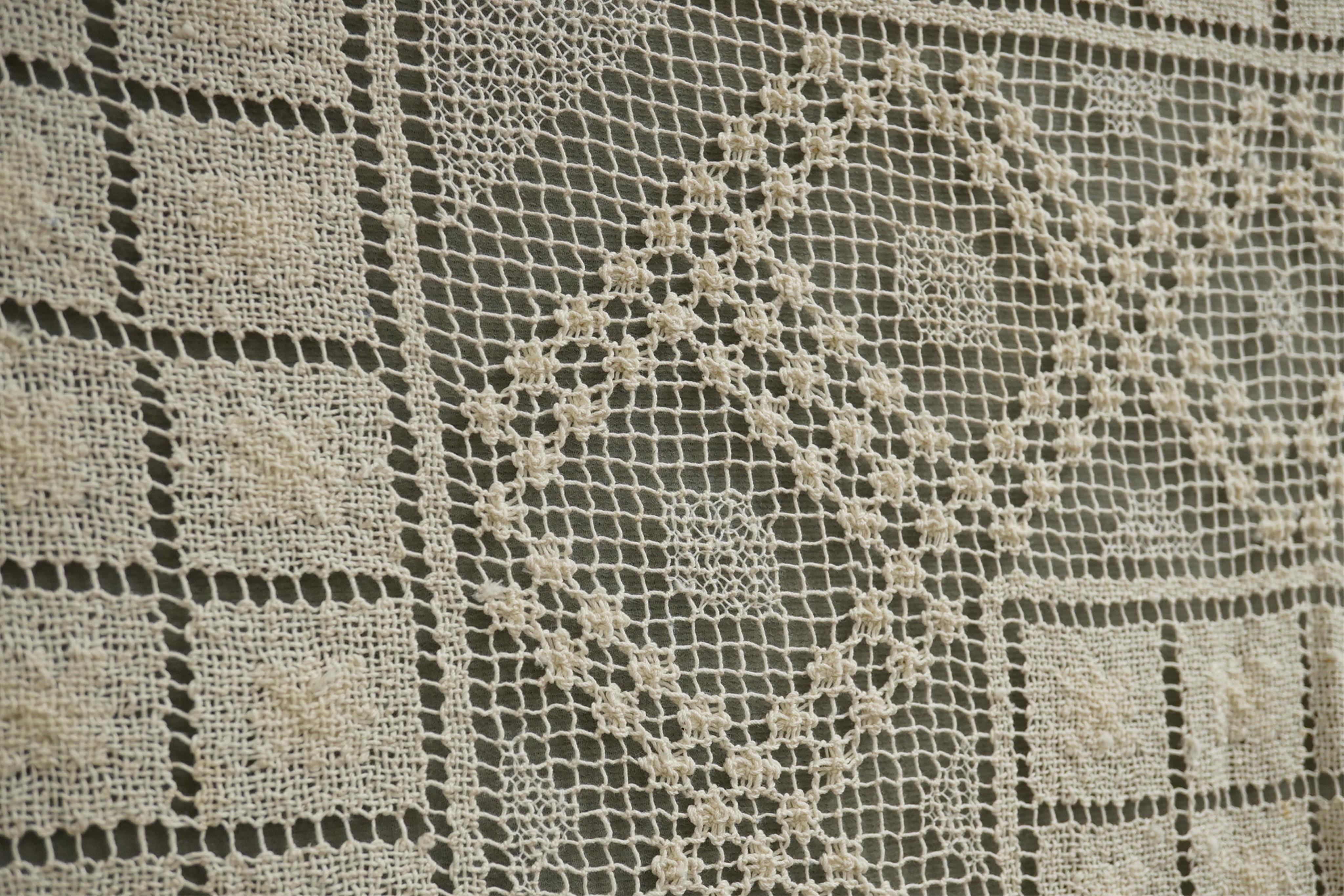 A collection of early 20th century and later crochet, cut work and drawn thread table linens and a large embroidered table cloth